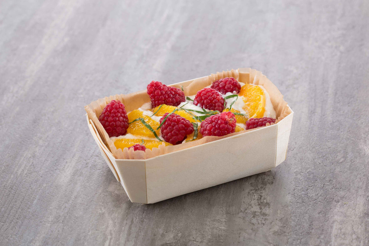 fruit parfait served in wooden pan 